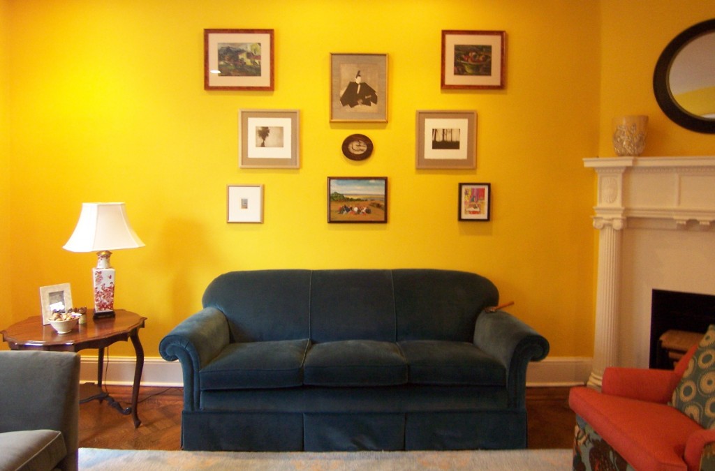 Art wall in yellow living room