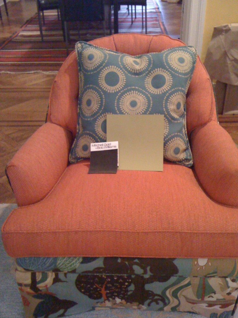 Paint and fabric swatches on orange chair