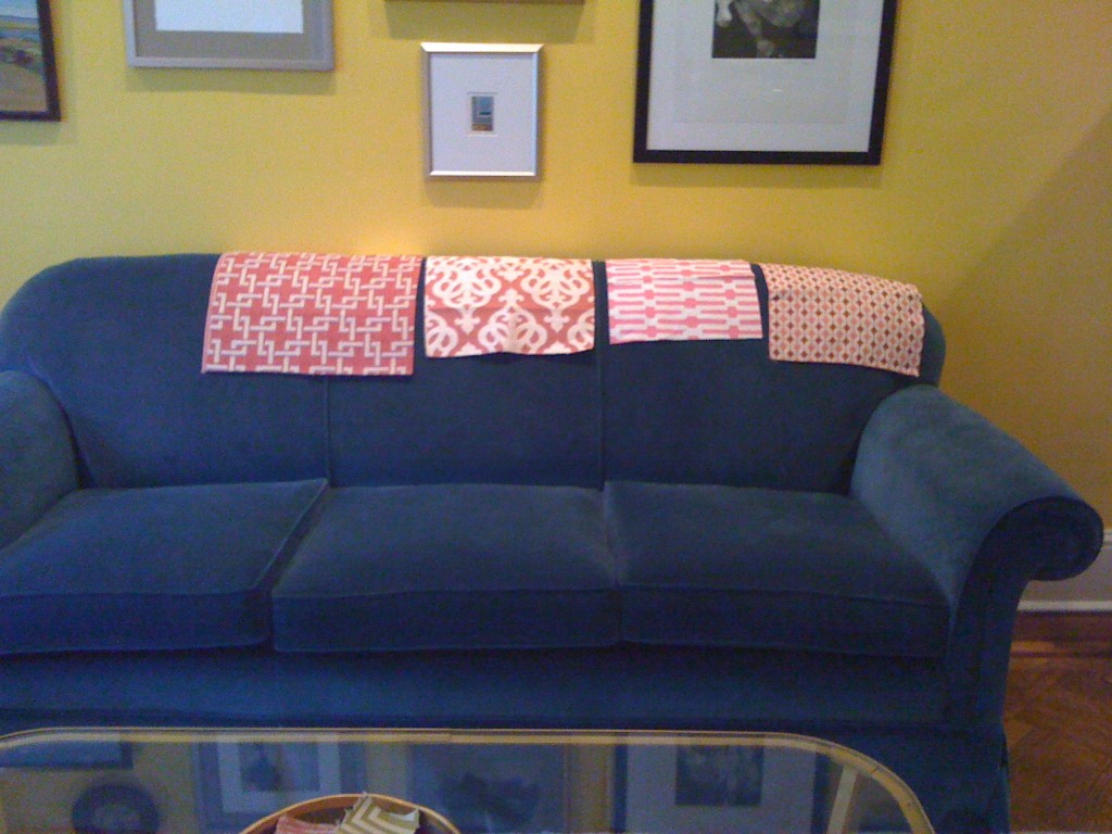 Pink fabric swatches on blue sofa
