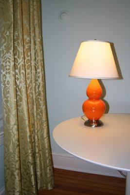 Orange lamp with green drapes