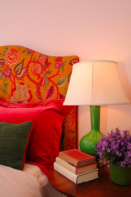 Floral headboard with green lamp