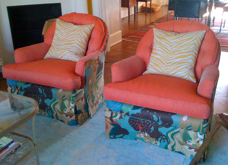 Chairs upholstered in orange herringbone and Schumacher Pearl River chairs