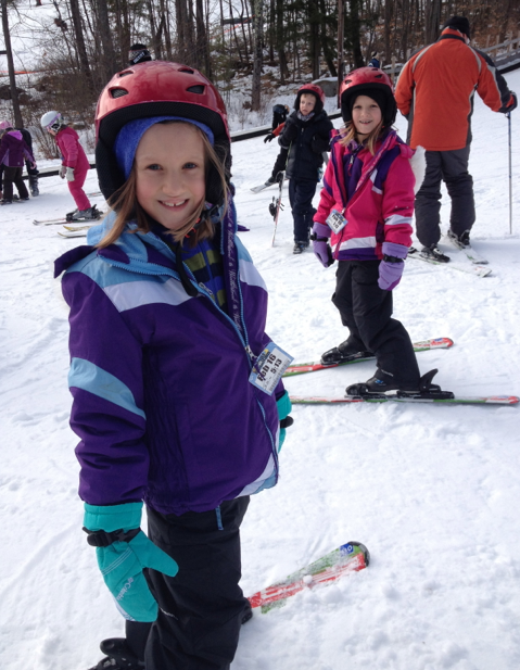 Girls skiing wearing helmets Girls skiing wearing helmets
