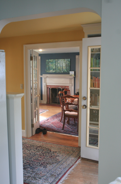 Yellow foyer hallway into blue living room 19th century farmhouse
