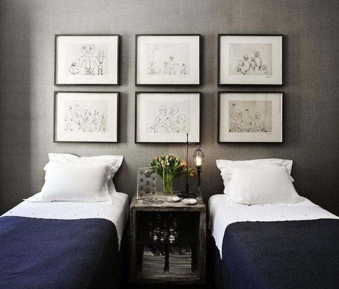 Black and blue: navy twin bedding against gray fabric wall with black frames