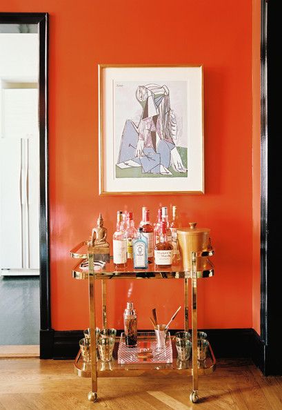 Bar cart in room with orange walls
