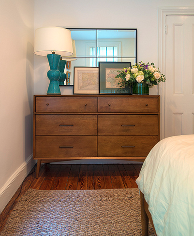 Wooden dresser with blue lamp