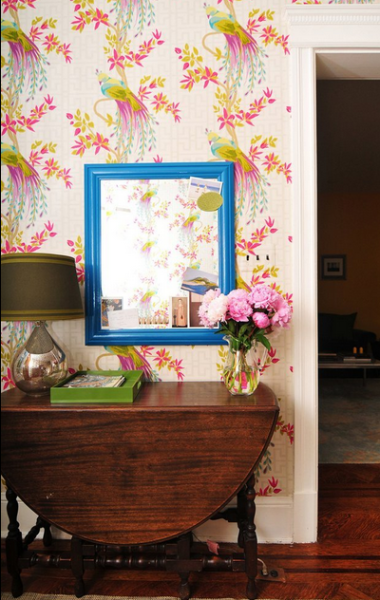 Foyer with peacock wallpaper and blue mirror