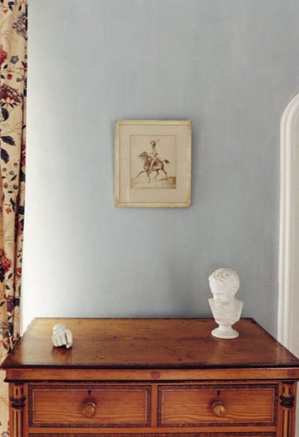 Room with light blue walls, antique ches