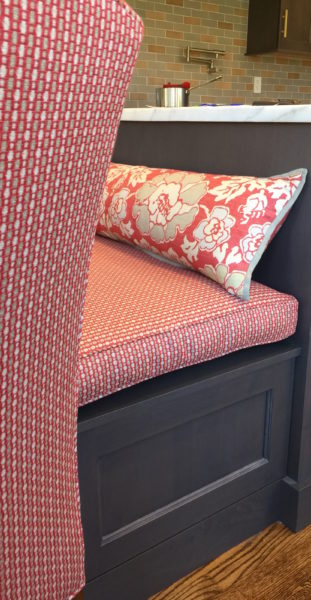 Red bench cushions and accent pillow on dining bench in DC-area kitchen renovated by Aidan Design with DC decorator Annie Elliott, bossy color