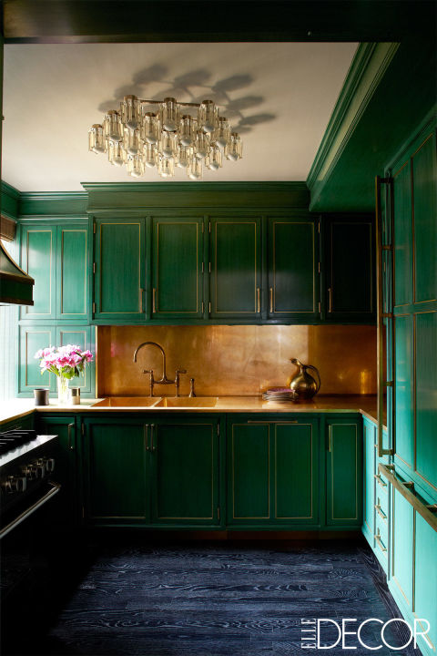 Cameron Diaz's glamorous NYC kitchen with green cabinets and a brass backsplash, designed by Kelly Wearstler