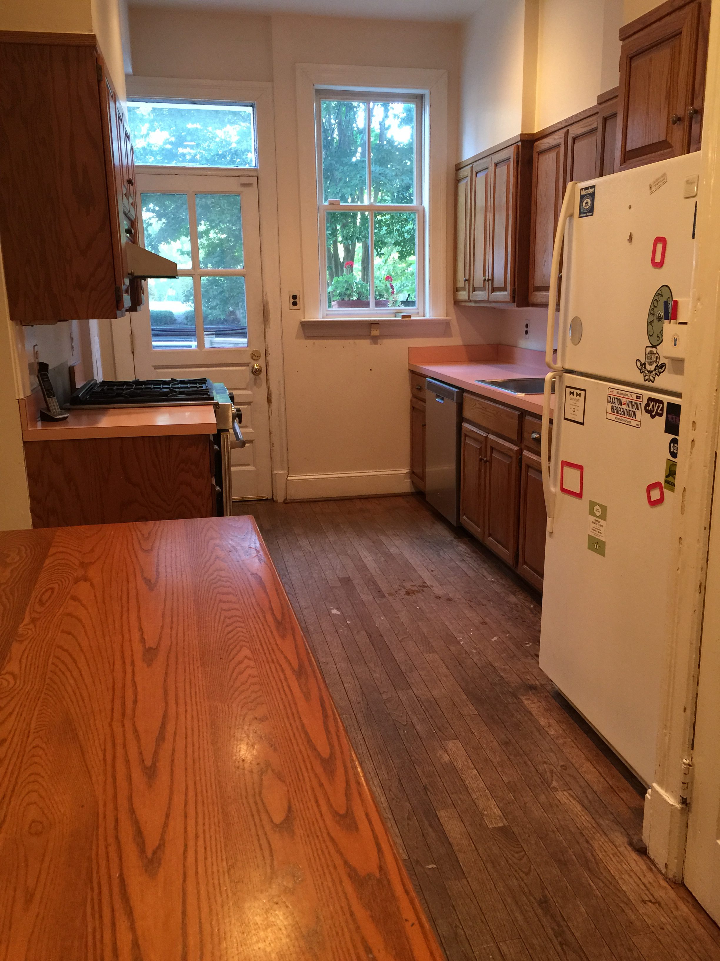 Galley kitchen with pink counters before renovation