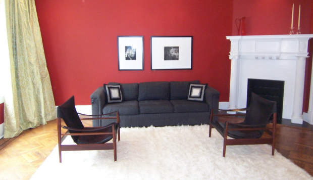 Red living room with black mid-century chairs