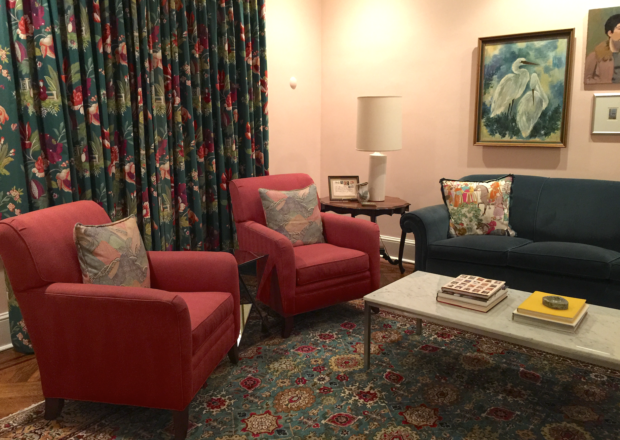 Pink living room with floral drapes and Oriental carpet