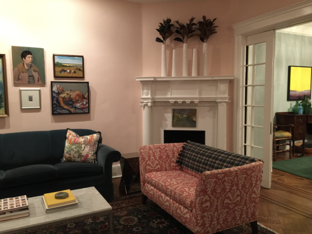 Pink living room with pink and white settee and fireplace