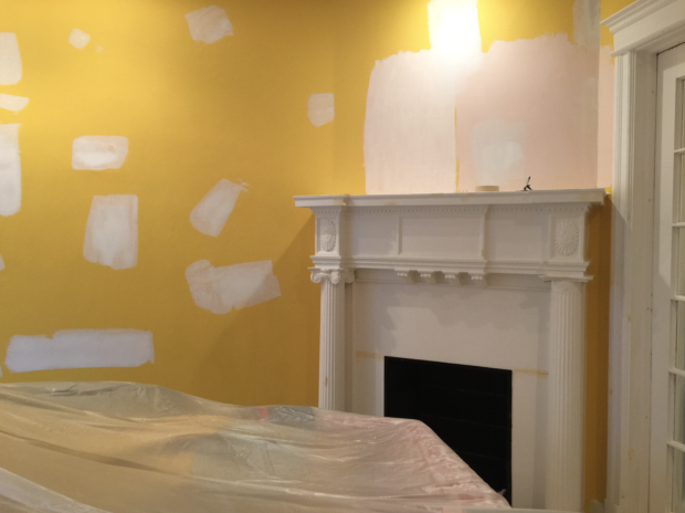 Yellow room with white fireplace