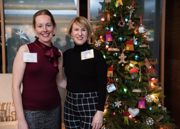 Two women with colorful Christmas tree