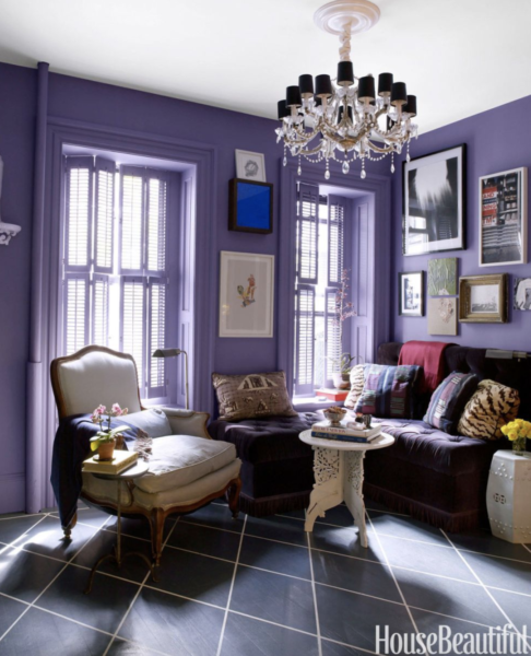 Small living room with purple walls and purple velvet banquette