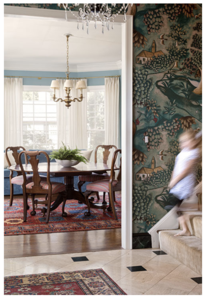 Green wallpapered foyer and light blue dining room