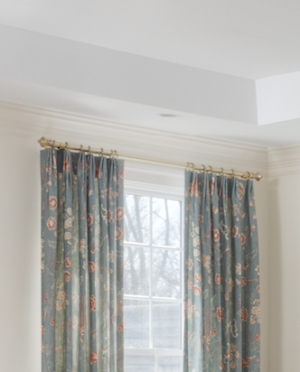 Close-up of window with blue floral drapes