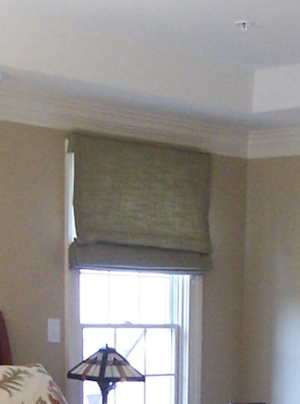 Close-up of window with Roman Shade