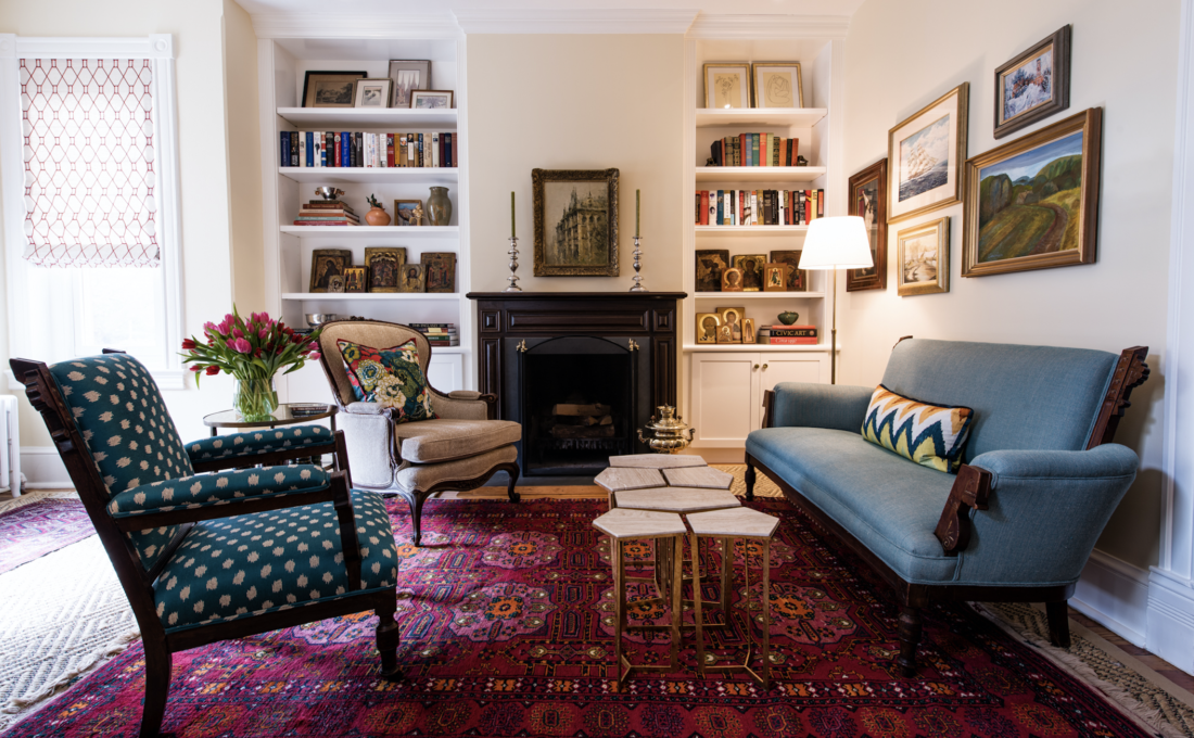 Living room with Oriental rug, fireplace, and built-in bookcases in the time of coronavirus