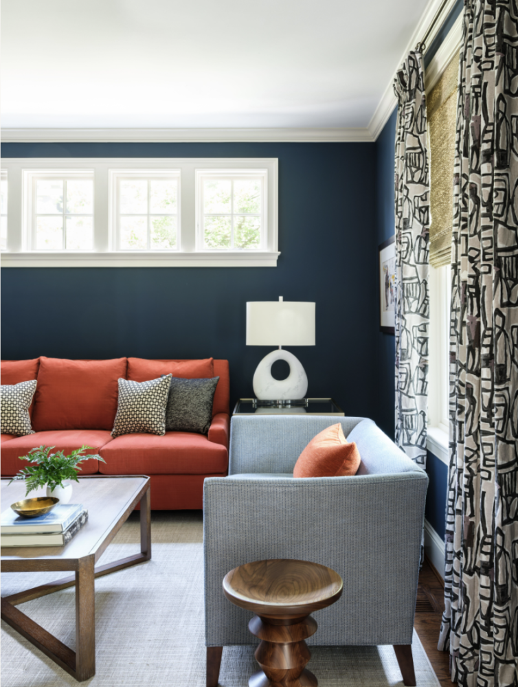 Navy blue living room with orange sofa