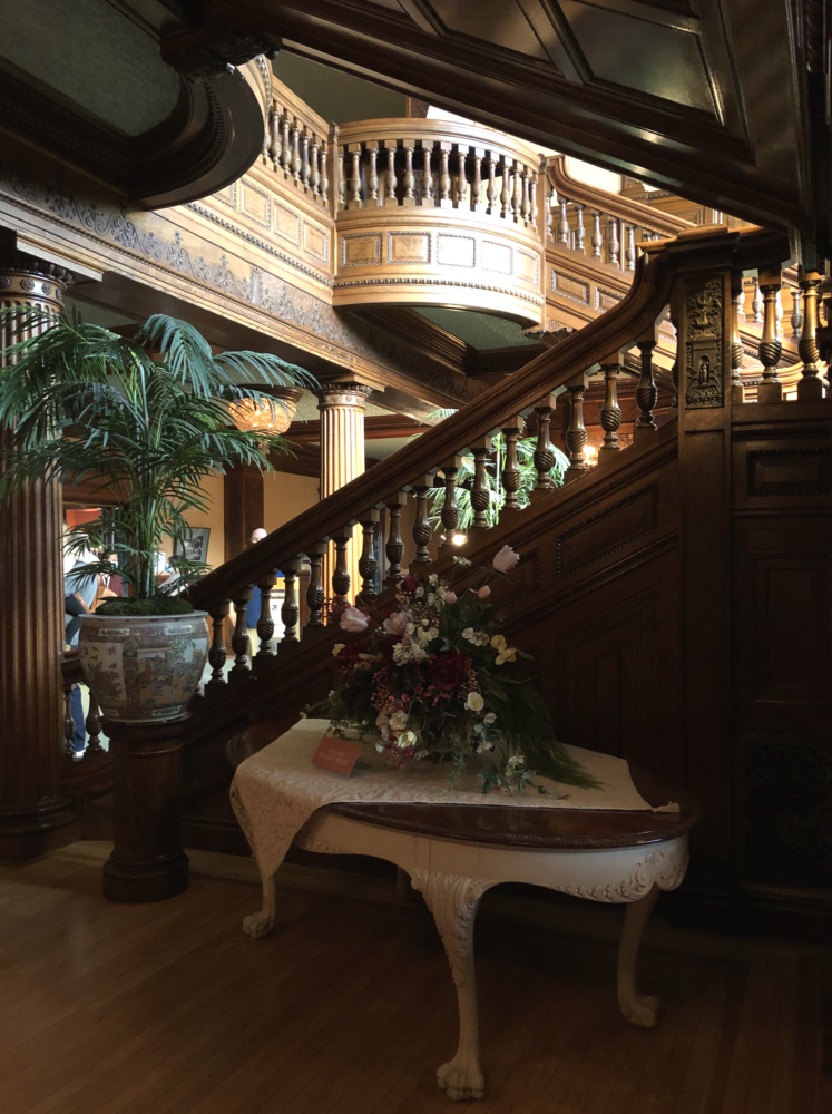 Dark carved wood staircase from James J. Hill House in St. Paul MN
