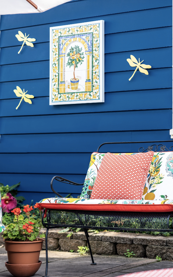 Ceramic tile on blue house with dragonflies