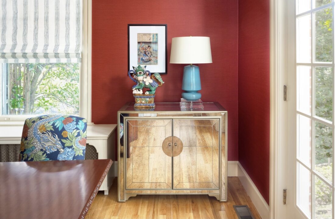 Red dining room with mirrored cabinet