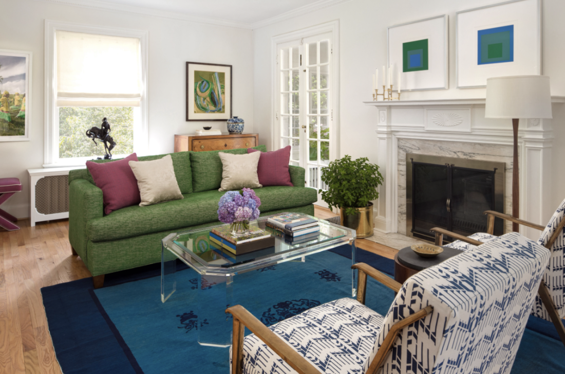 Living room with green sofa and blue rug