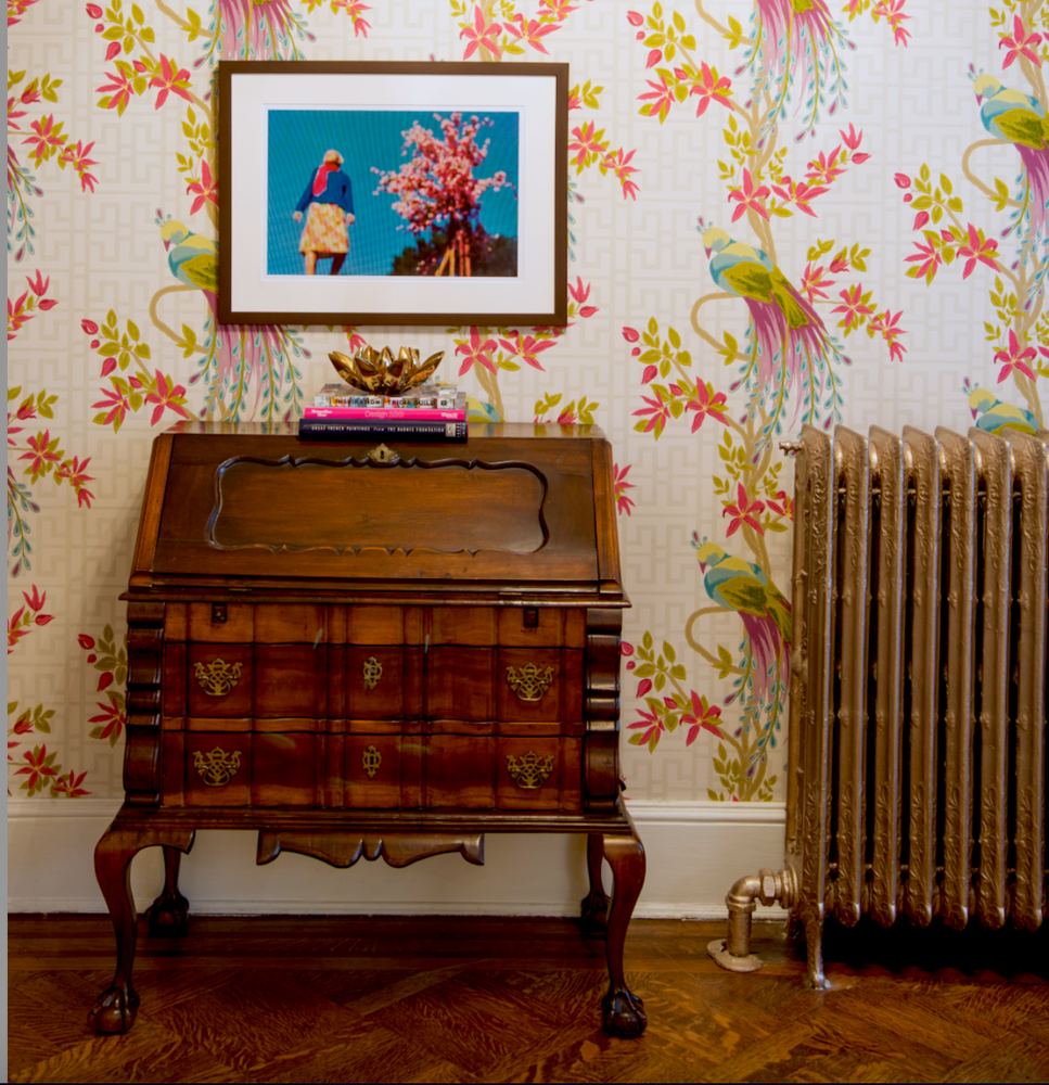 Antique secretary desk with antique radiator and paecock wallpaper