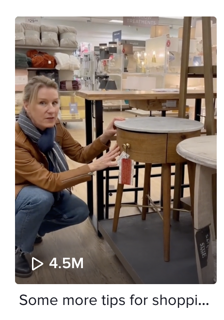 Woman kneeling next to table