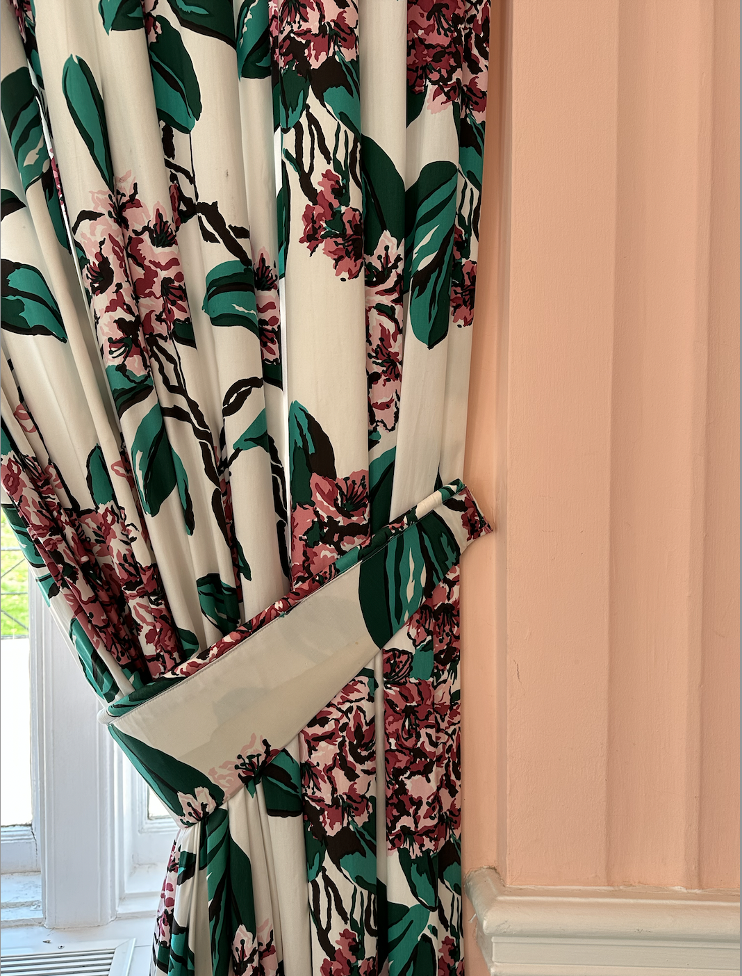 Floral window treatments and pink wall