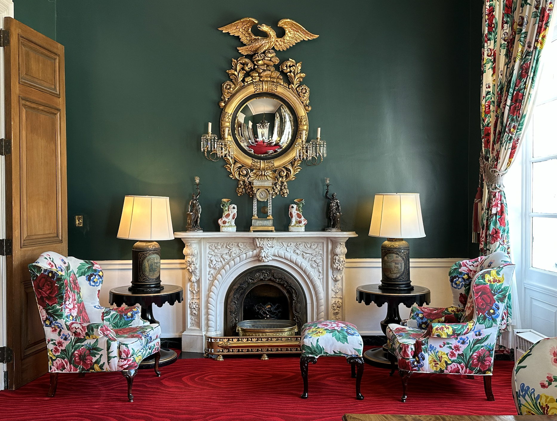 Writing room with green walls and red carpet