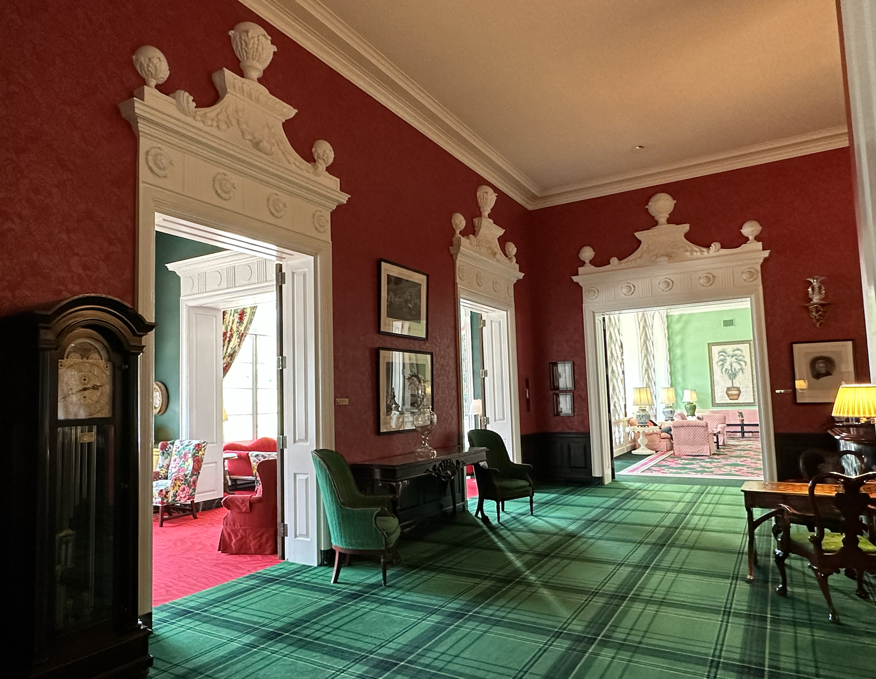 Hallway with red walls and green carpet