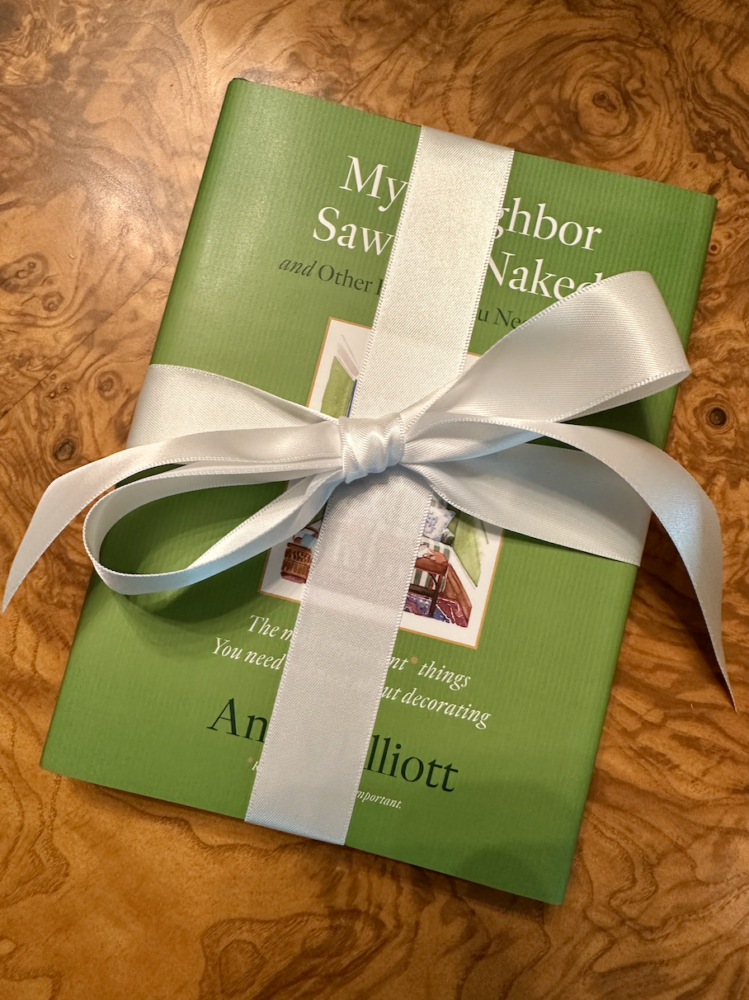 Small green book wrapped with a bow