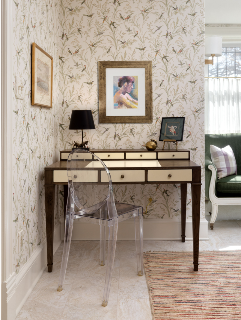 Brown and white desk against white floral wallpaper