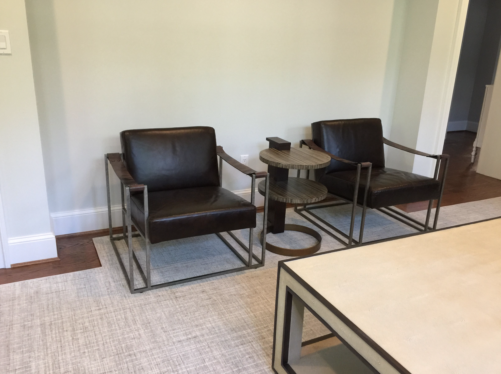 Two leather chairs against a wall