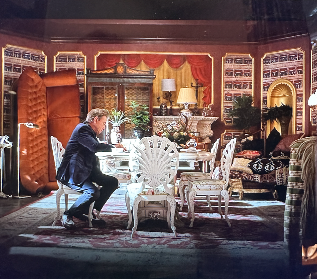 Man at a table in a colorful, maximalist dining room