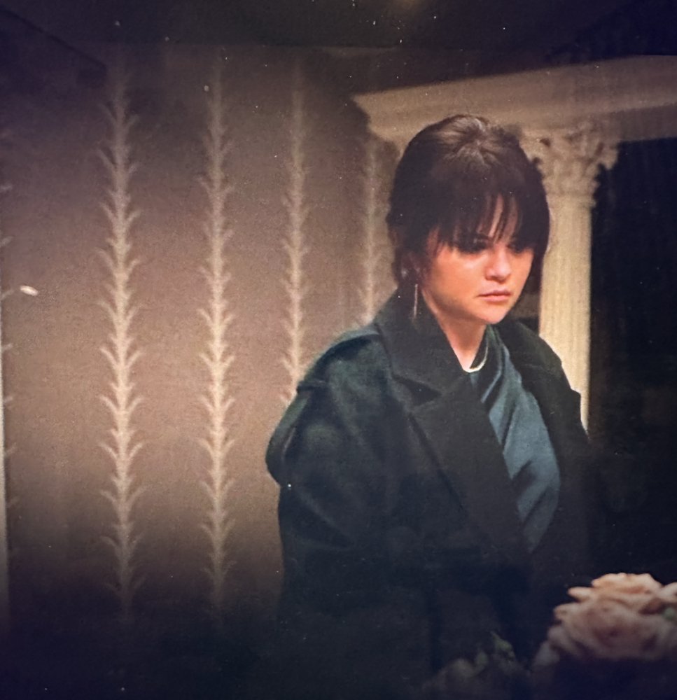 Woman in room with beige and white wallpaper