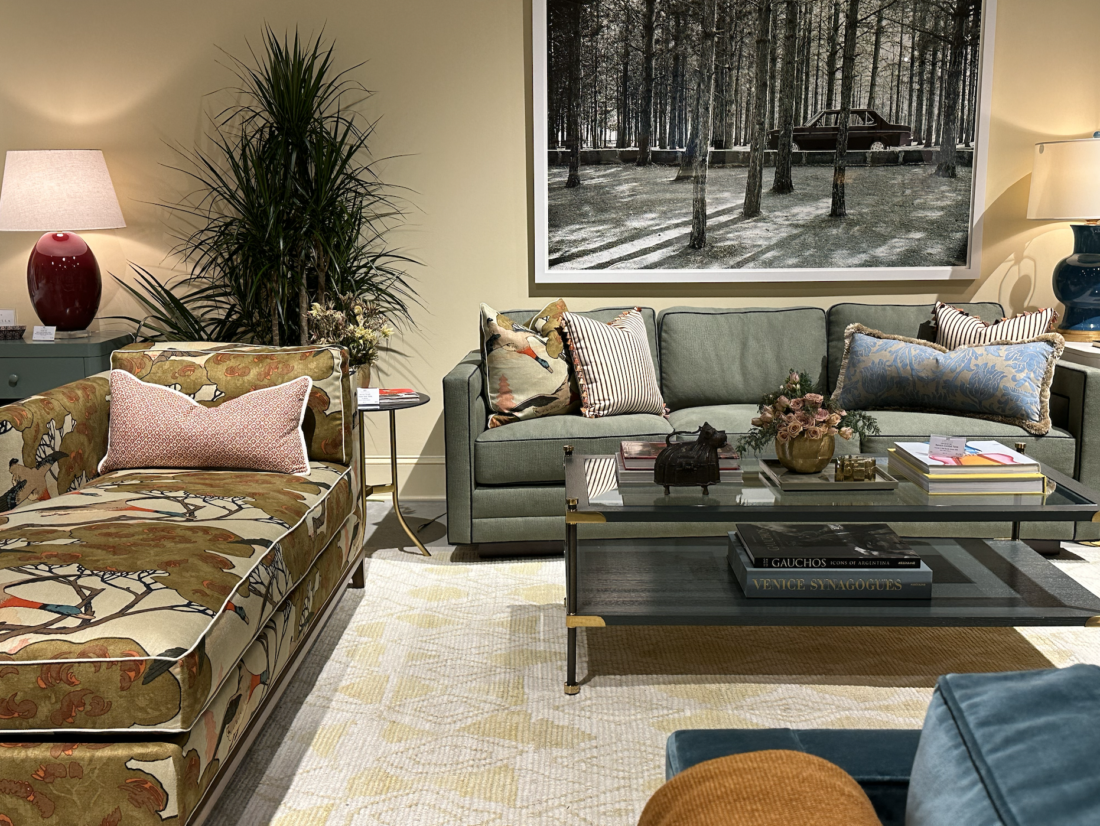 living room in earth tones with two sofas, one green sofa