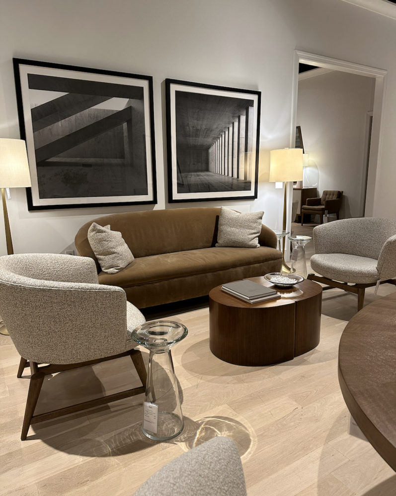 living room with brown sofa and black and white art