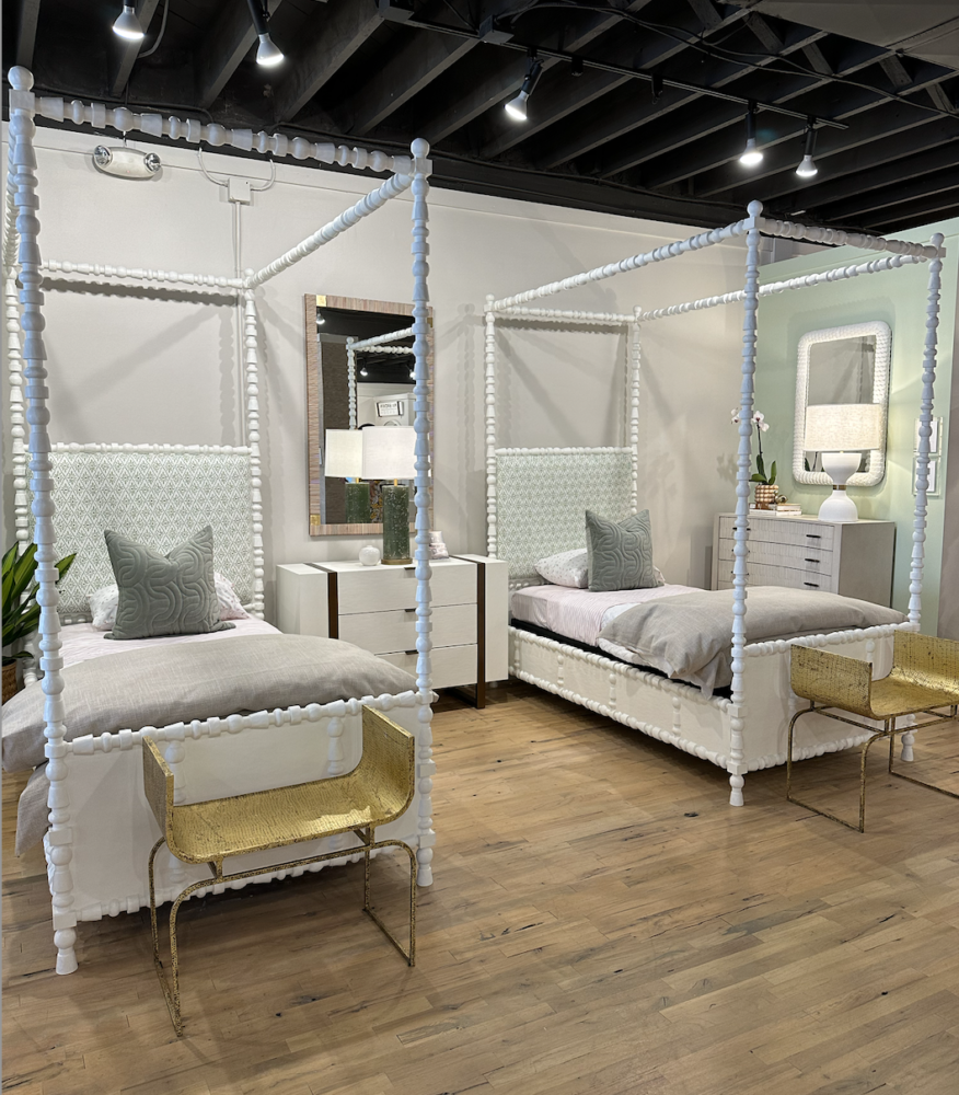 Pair of white four-poster twin beds in children's room