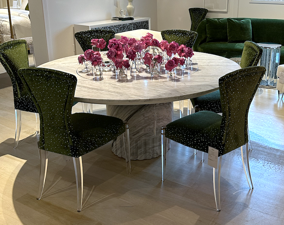 Round marble dining table with green and lucite dining chairs