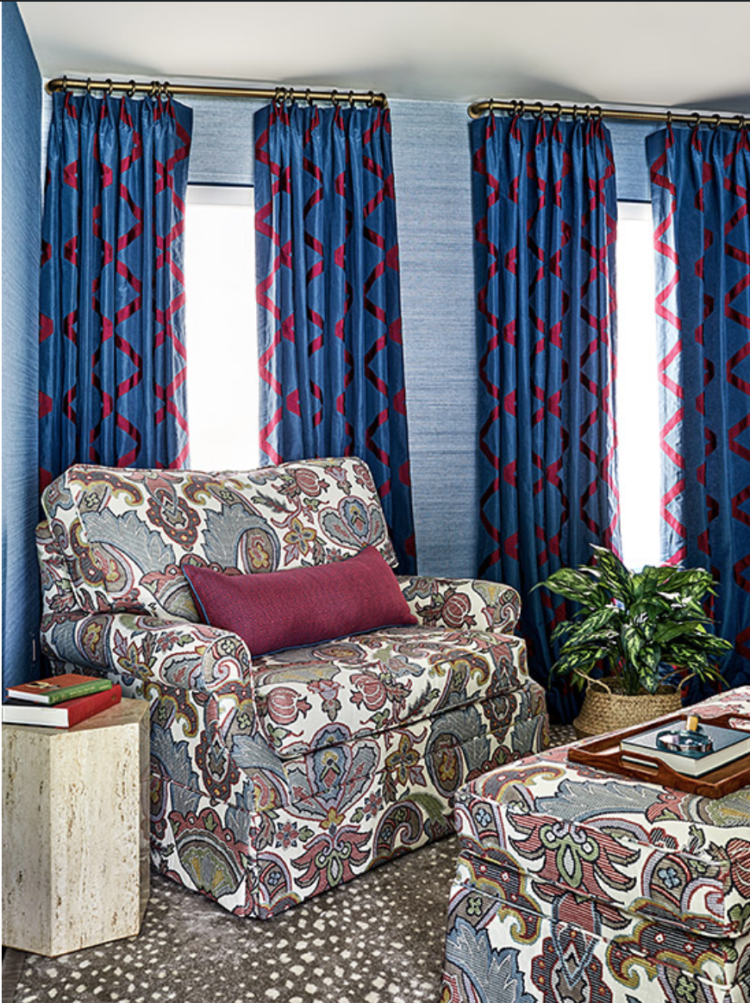 Blue room with cozy large chair and many different patterns in an urban family room