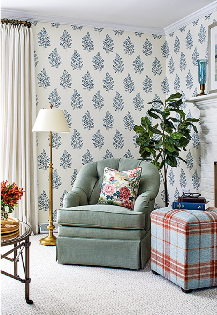 Light green lounge chair with light blue and plaid ottoman in bright sunny room