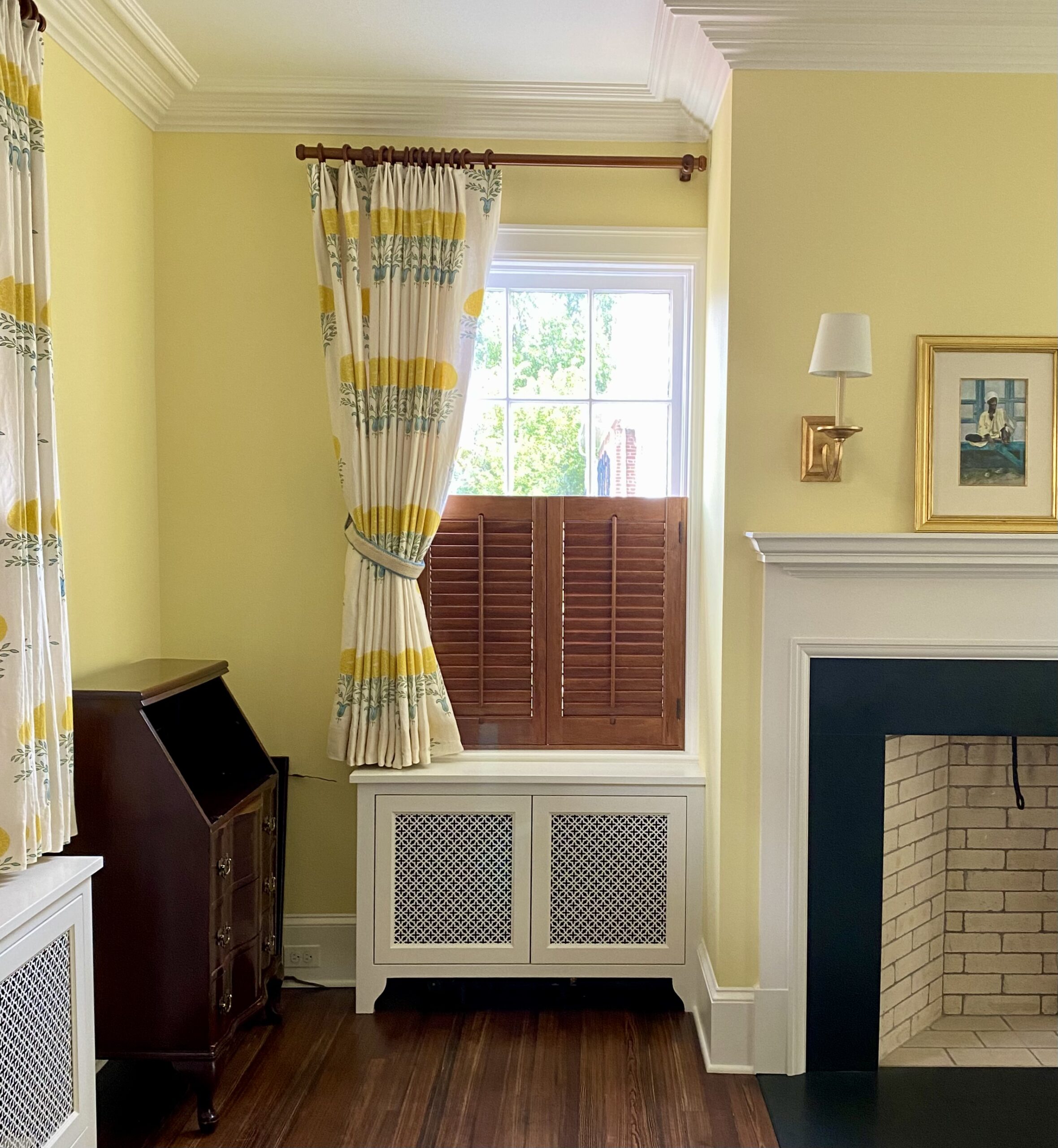 Yellow room with flowered curtains tied back