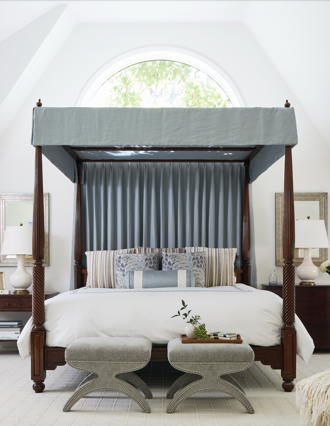 Bedroom with white walls and light blue canopy bed