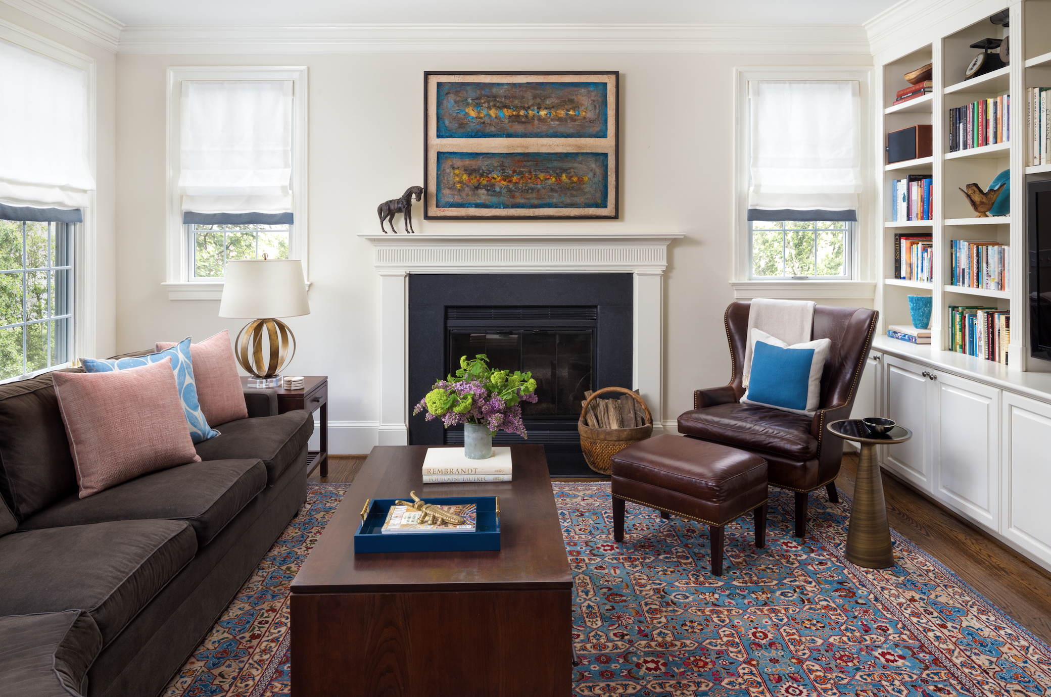Family room with white walls and blue patterned rug